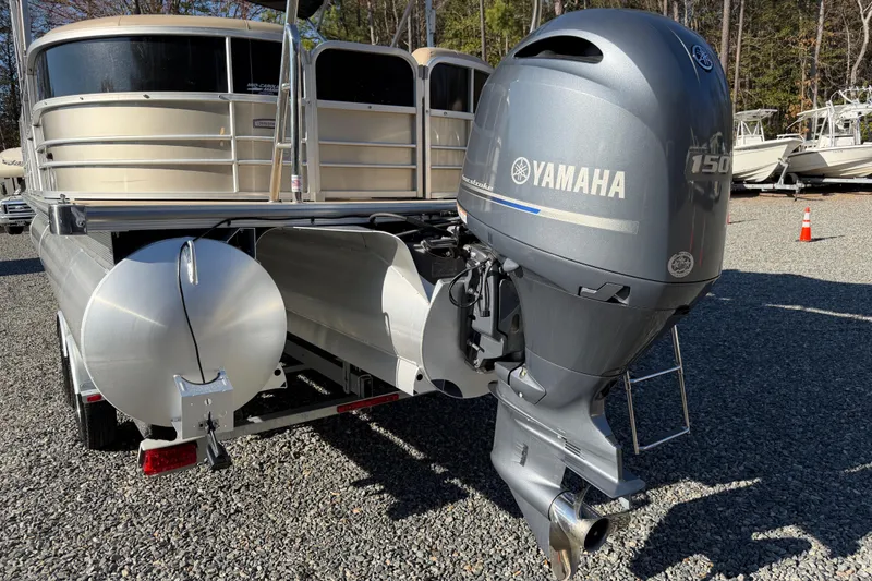 Slide: The Image of 2020 Berkshire 25SL pontoon boat with Yamaha 150 outboard motor, parked on gravel. - 21