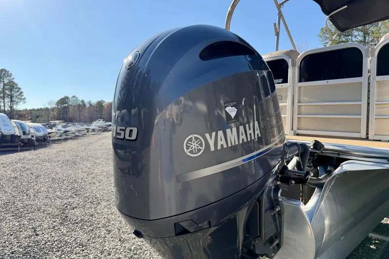 Slide: The Image of Yamaha outboard motor on a 2020 Berkshire 25SL pontoon boat, parked outdoors. - 4