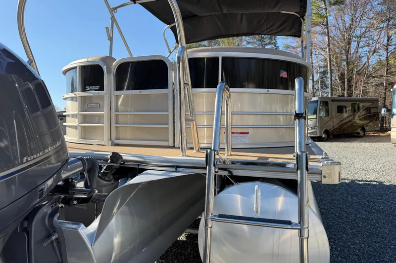 Slide: The Image of 2020 Berkshire 25SL pontoon boat with four-stroke engine, parked outdoors. - 6
