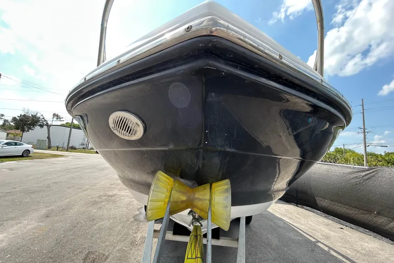 Slide: The Image of 2012 Crownline 236 SC boat on trailer, viewed from the front under a clear sky. - 10