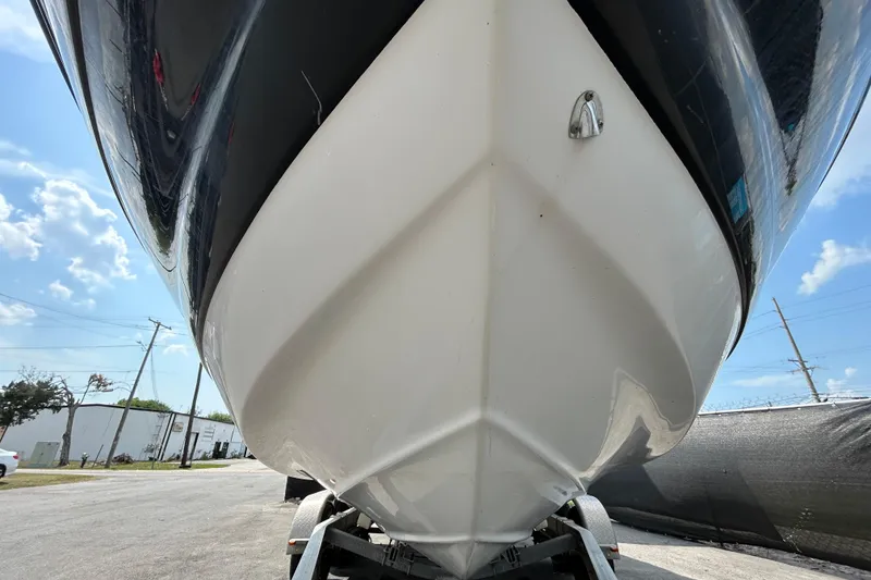 Slide: The Image of 2012 Crownline 236 SC boat on trailer, viewed from the front under a clear sky. - 11