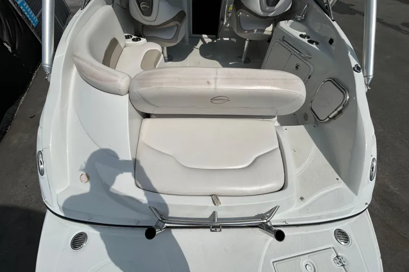 Slide: The Image of 2012 Crownline 236 SC boat interior with white seating and steering area. - 12