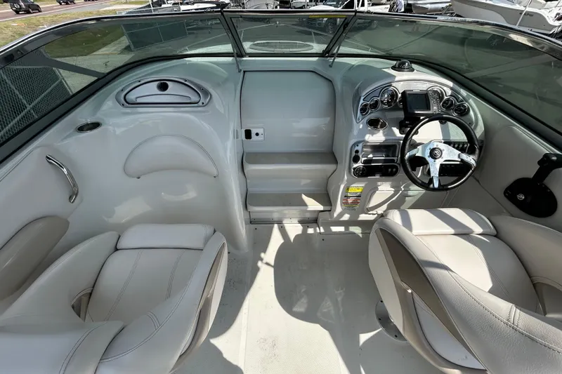 Slide: The Image of Interior view of 2012 Crownline 236 SC boat, featuring steering wheel and seating. - 18
