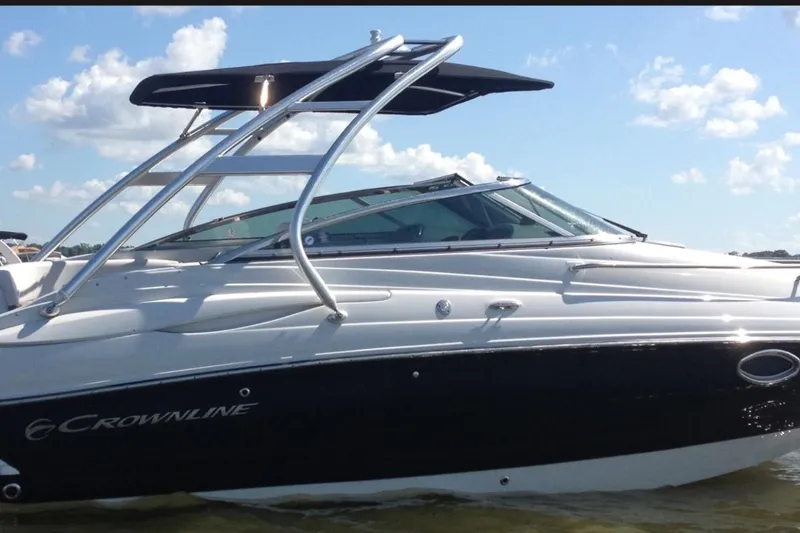 Slide: The Image of 2012 Crownline 236 SC boat on water under a clear sky. - 2