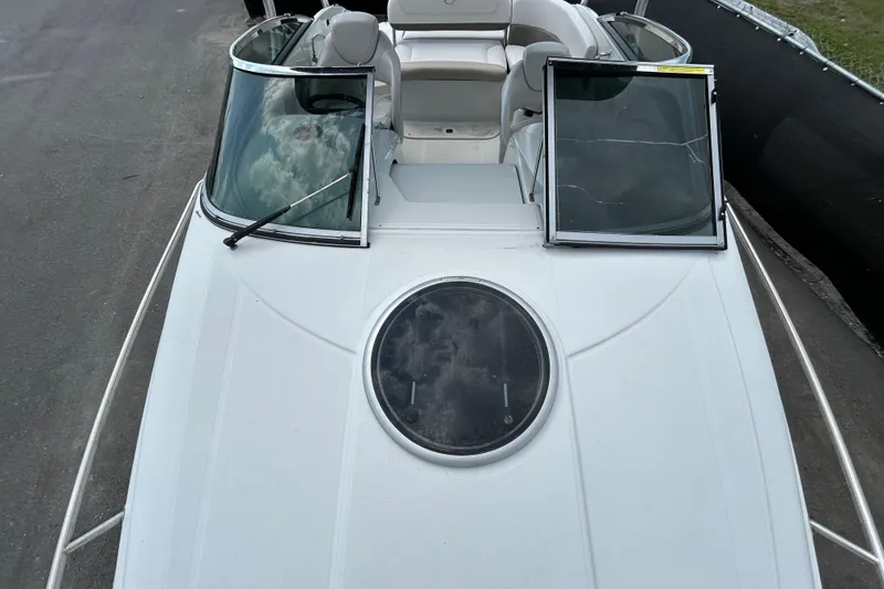 Slide: The Image of 2012 Crownline 236 SC boat with open windshield and circular hatch on deck. - 23