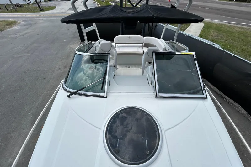 Slide: The Image of 2012 Crownline 236 SC boat with open windshield and black canopy. - 24