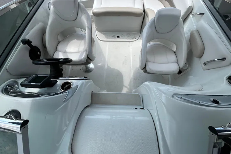 Slide: The Image of Interior of a 2012 Crownline 236 SC boat with white seating and steering console. - 25