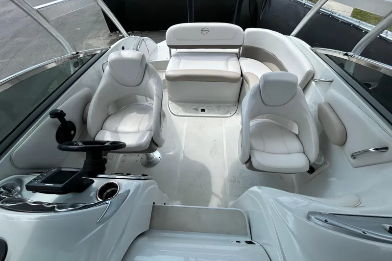 Slide: The Image of Interior of a 2012 Crownline 236 SC boat with white seating and steering console. - 26