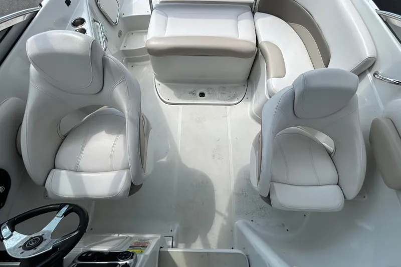Slide: The Image of Interior of 2012 Crownline 236 SC boat with white seating and steering wheel. - 27