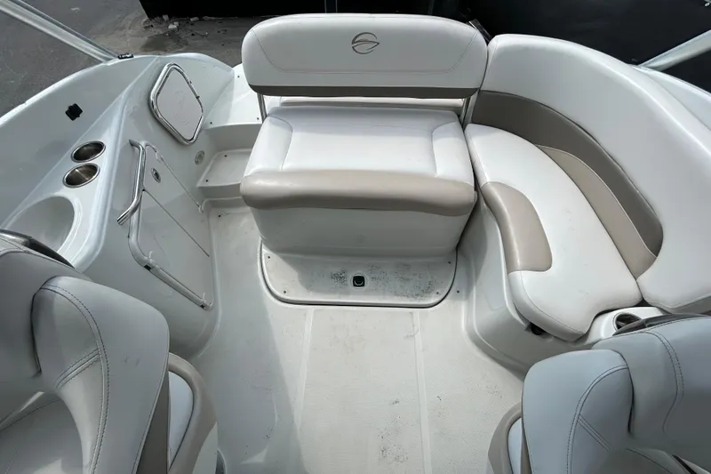 Slide: The Image of 2012 Crownline 236 SC boat interior with white and beige seating arrangement. - 29