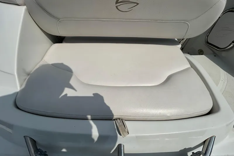 Slide: The Image of Crownline 236 SC 2012 boat seat with white upholstery and logo detail. - 34