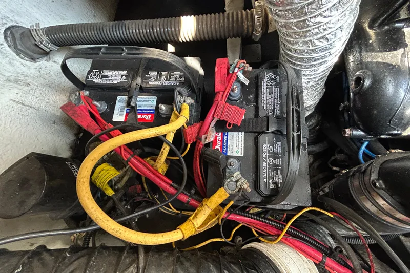 Slide: The Image of Battery compartment of a 2012 Crownline 236 SC boat with wiring and connections. - 37