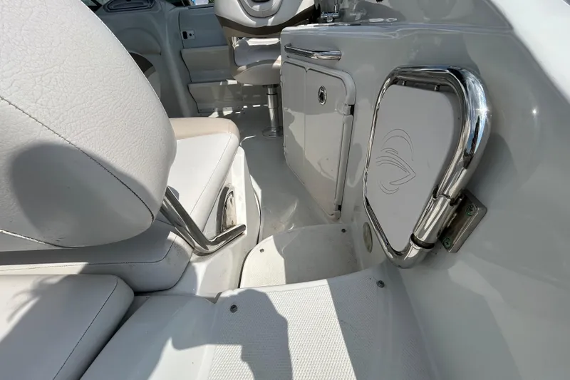 Slide: The Image of Interior view of a 2012 Crownline 236 SC boat, featuring white seating and chrome accents. - 39