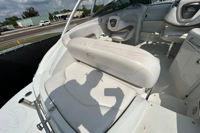 Slide: The Image of 2012 Crownline 236 SC boat interior with white seating and steering area. - 41