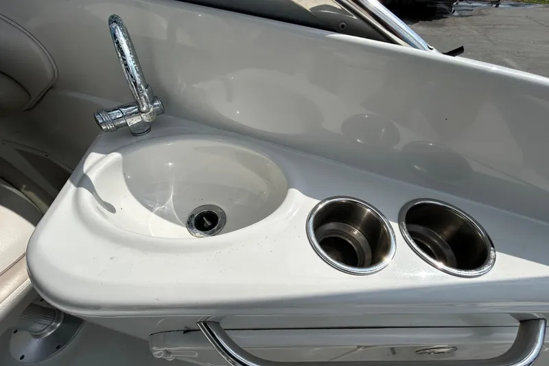 Slide: The Image of 2012 Crownline 236 SC boat sink with faucet and cup holders. - 43