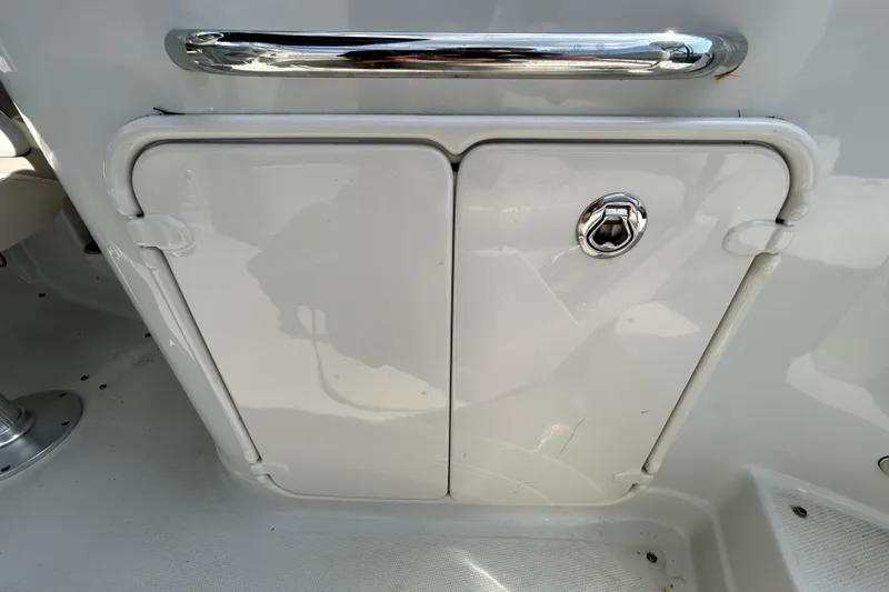Slide: The Image of Storage compartment on a 2012 Crownline 236 SC boat with chrome handle and lock. - 44
