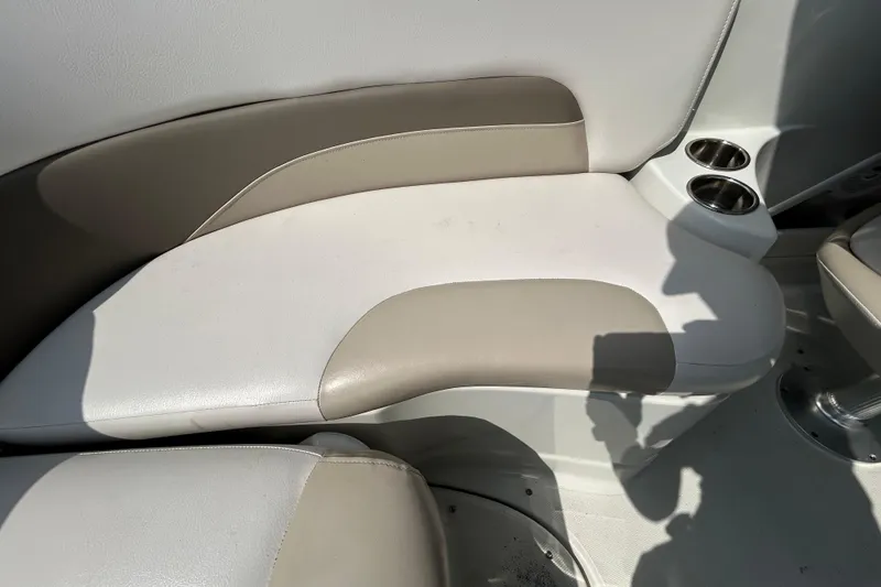 Slide: The Image of Crownline 236 SC 2012 boat interior seating with cup holders, beige and white upholstery. - 50