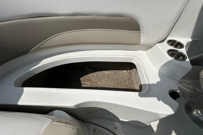 Slide: The Image of 2012 Crownline 236 SC boat interior storage compartment with cup holders. - 51