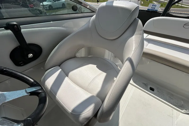 Slide: The Image of Captain's seat in 2012 Crownline 236 SC boat, featuring sleek design and comfortable upholstery. - 53