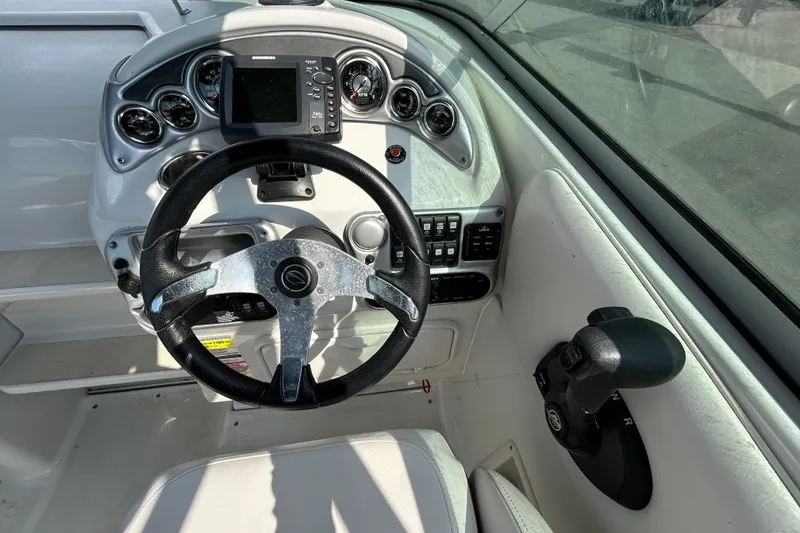 Slide: The Image of Steering console of a 2012 Crownline 236 SC boat with gauges and controls. - 58
