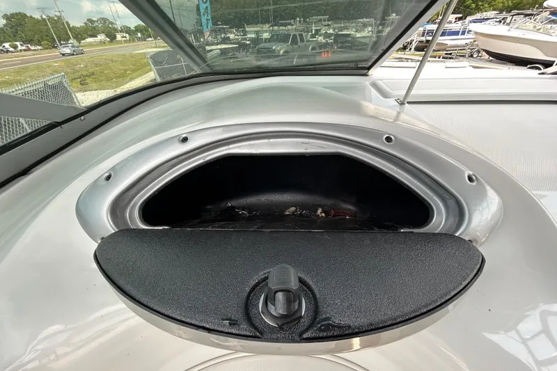 Slide: The Image of 2012 Crownline 236 SC boat storage compartment with open hatch, showcasing interior space. - 62