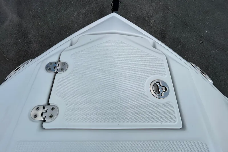 Slide: The Image of 2012 Crownline 236 SC boat hatch with textured surface and metal hinges. - 64