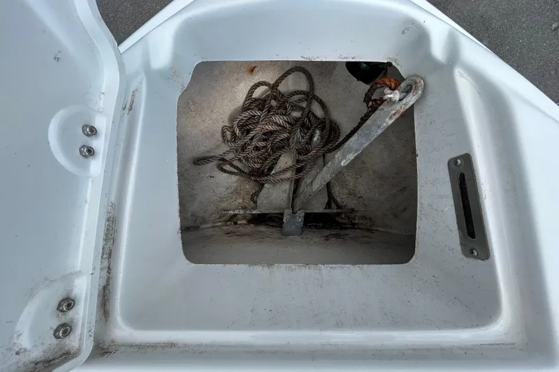 Slide: The Image of Anchor and rope storage compartment on a 2012 Crownline 236 SC boat. - 66