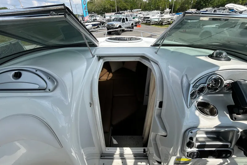 Slide: The Image of 2012 Crownline 236 SC boat interior with open cabin door and dashboard view. - 68