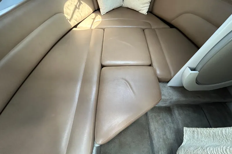 Slide: The Image of 2012 Crownline 236 SC cabin interior with beige leather seating and cushions. - 70