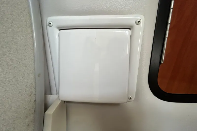 Slide: The Image of White electrical panel on 2012 Crownline 236 SC boat interior. - 77