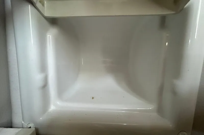 Slide: The Image of Empty storage compartment in a 2012 Crownline 236 SC boat. - 79