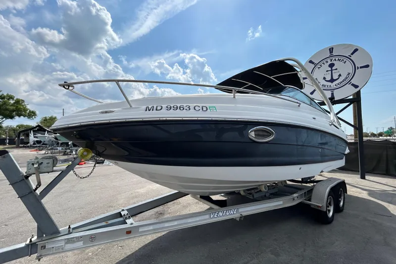 Slide: The Image of 2012 Crownline 236 SC boat on trailer under a partly cloudy sky. - 8