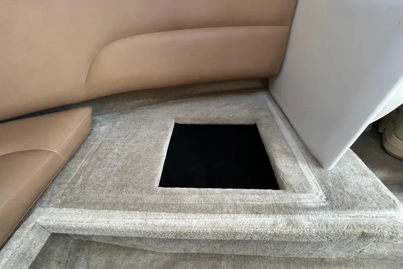 Slide: The Image of Interior storage compartment of 2012 Crownline 236 SC boat with beige upholstery. - 82