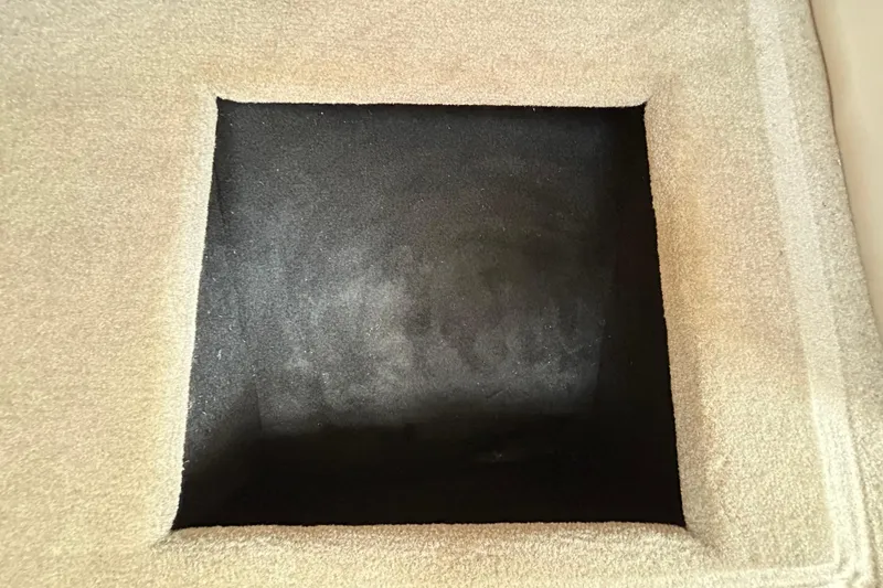 Slide: The Image of Carpeted storage compartment in a 2012 Crownline 236 SC boat. - 83