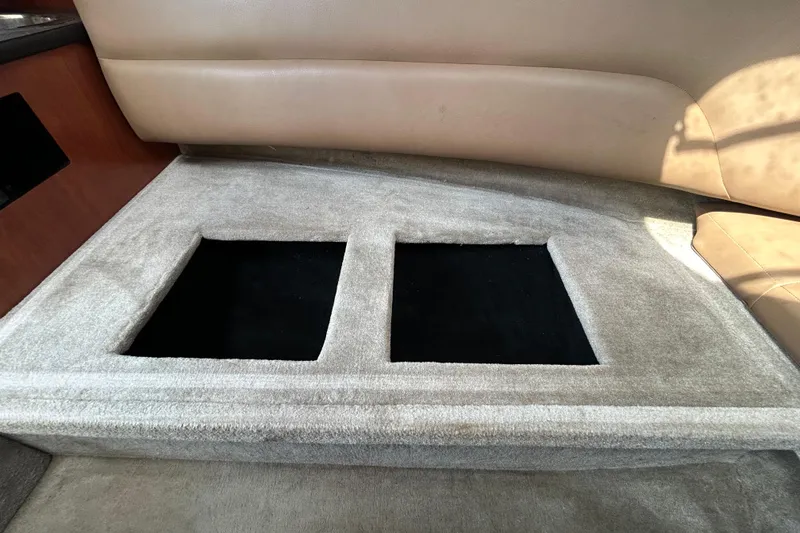 Slide: The Image of Interior view of 2012 Crownline 236 SC boat with carpeted flooring and storage compartments. - 86