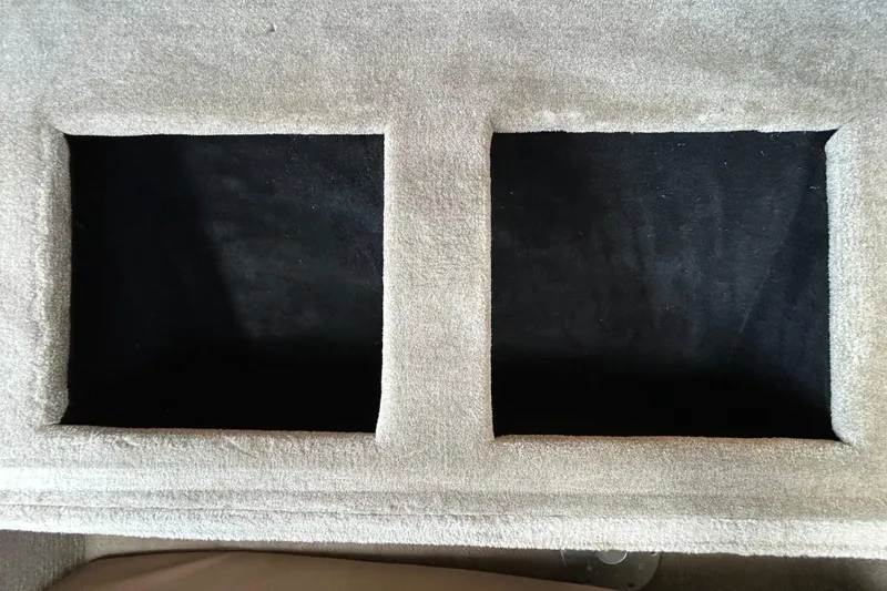 Slide: The Image of Crownline 236 SC 2012 boat interior storage compartments, beige and black upholstery. - 87