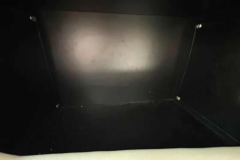 Slide: The Image of Empty storage compartment inside a 2012 Crownline 236 SC boat. - 91