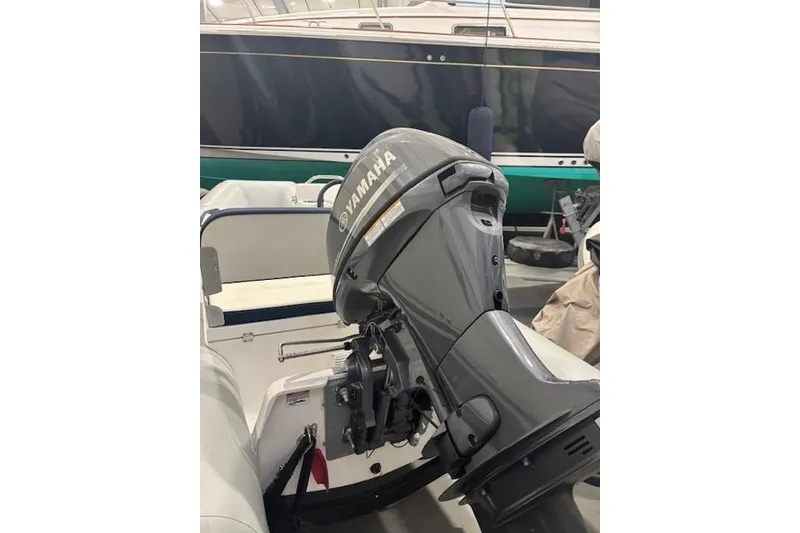 Slide: The Image of 2025 AB Inflatables Mares 12 VSX with Yamaha outboard motor in a marina setting. - 13