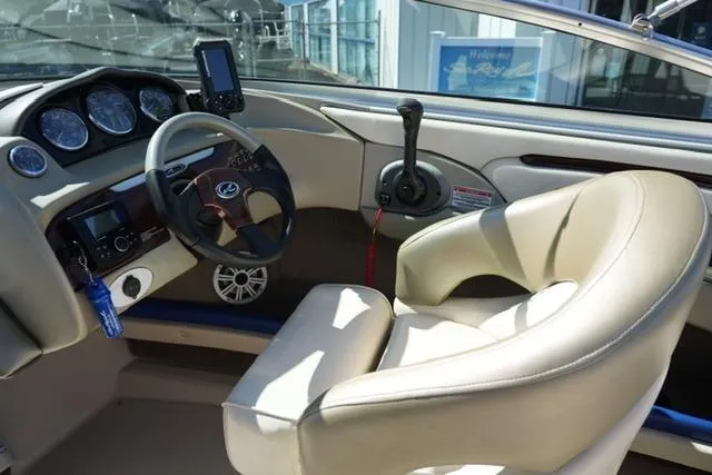 Slide: The Image of Interior of a 2004 Sea Ray 200 Select boat with steering wheel and controls. - 15