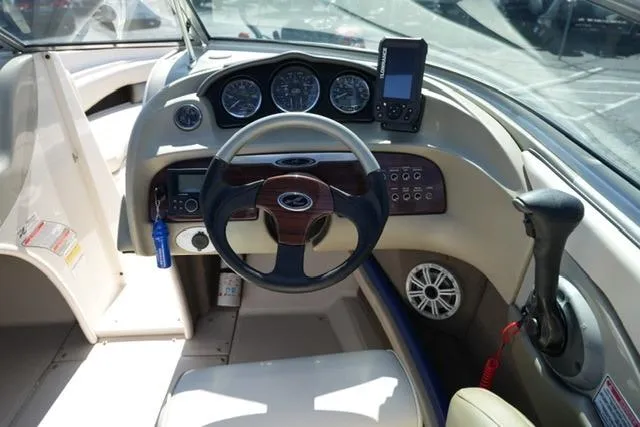 Slide: The Image of 2004 Sea Ray 200 Select boat dashboard with steering wheel and control panel. - 16