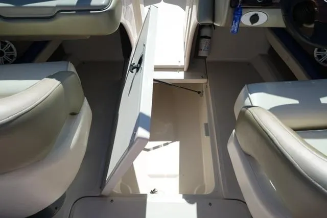 Slide: The Image of 2004 Sea Ray 200 Select boat interior with open storage compartment. - 18