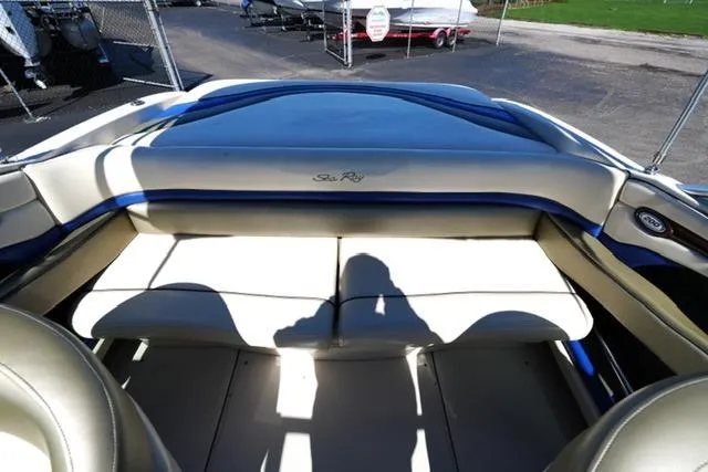 Slide: The Image of 2004 Sea Ray 200 Select boat interior with beige seating and blue accents. - 19