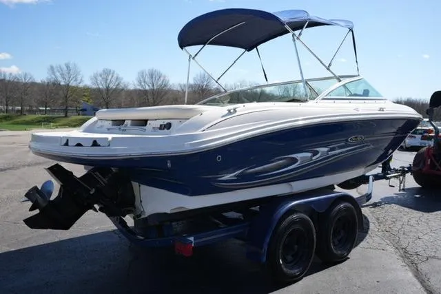 Slide: The Image of 2004 Sea Ray 200 Select boat on trailer with blue hull and canopy. - 5