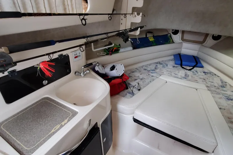 Slide: The Image of Interior of 2003 Grady-White Marlin 300 boat with fishing rods and seating area. - 10
