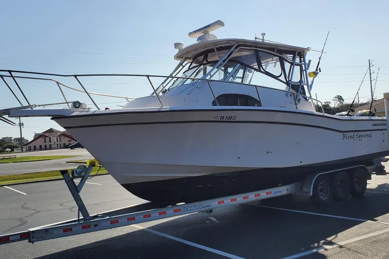 Slide: The Image of 2003 Grady-White Marlin 300 boat on trailer in parking lot, side view. - 11