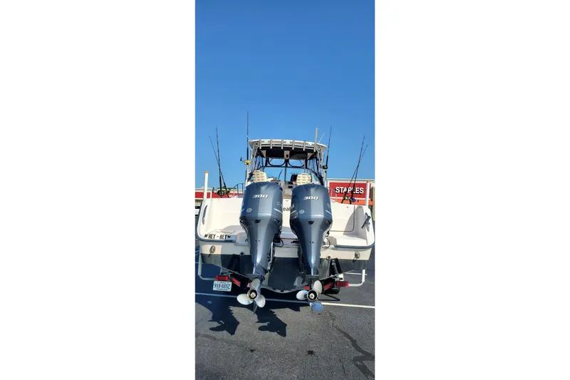 Slide: The Image of 2003 Grady-White Marlin 300 boat with dual outboard engines in a parking lot. - 13
