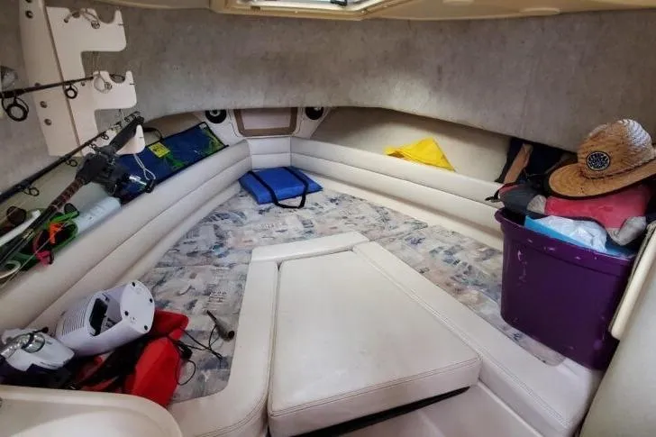 Slide: The Image of Interior cabin of a 2003 Grady-White Marlin 300 boat with fishing gear and storage. - 14