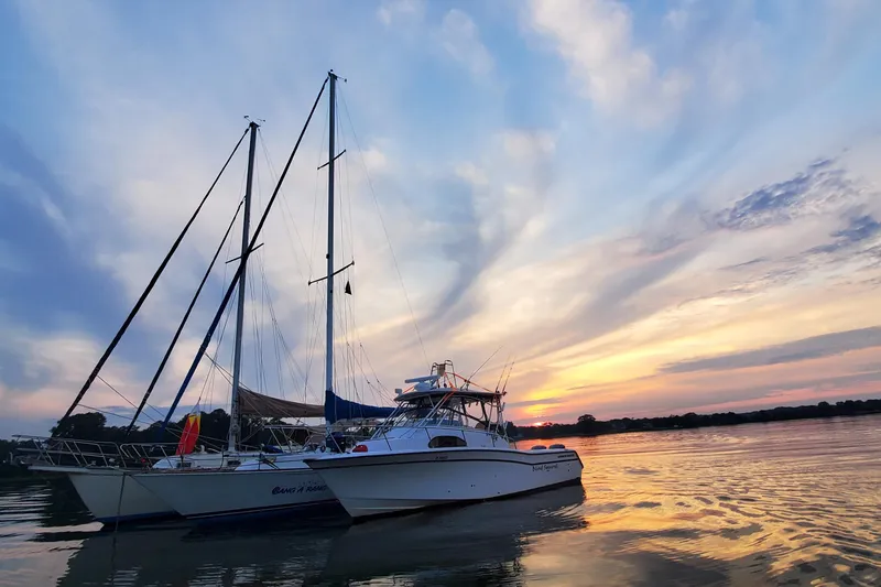 Slide: The Image of Boats anchored at sunset, featuring a 2003 Grady-White Marlin 300. - 2