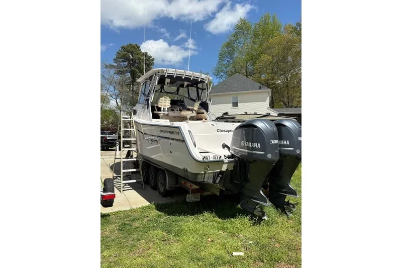 Slide: The Image of 2003 Grady-White Marlin 300 boat with twin Yamaha engines on a trailer. - 25