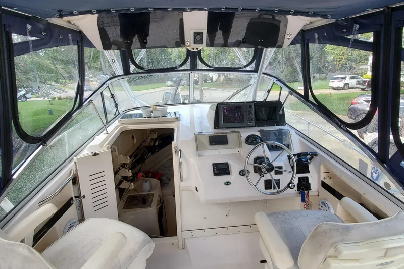 Slide: The Image of 2003 Grady-White Marlin 300 boat interior with steering wheel and navigation equipment. - 3